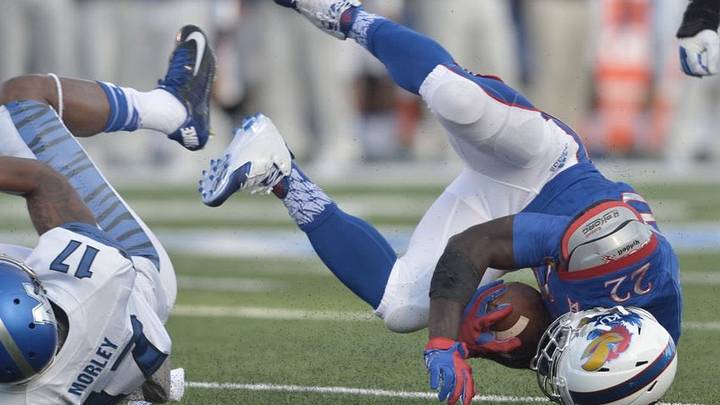 Sep 12, 2015; Lawrence, KS, USA; Kansas Jayhawks running back Ke'aun Kinner (22) is tackled by Memphis Tigers defensive back Chris Morley (17) during the first half at Memorial Stadium. Mandatory Credit: Denny Medley-USA TODAY Sports